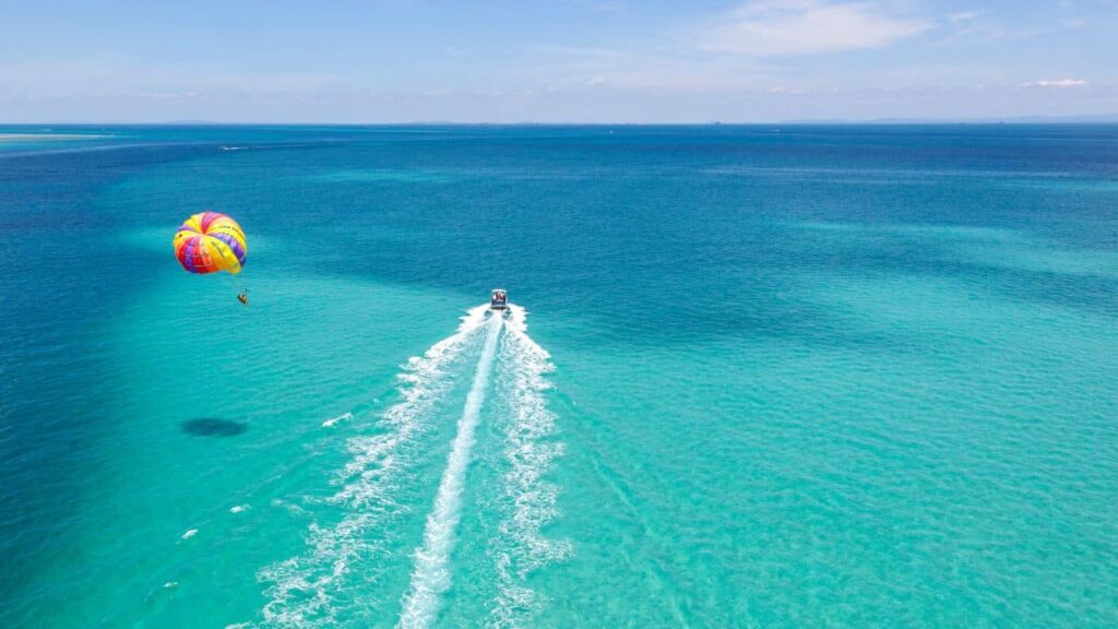 How Do I Experience The Thrill Of Parasailing Over The Ocean?